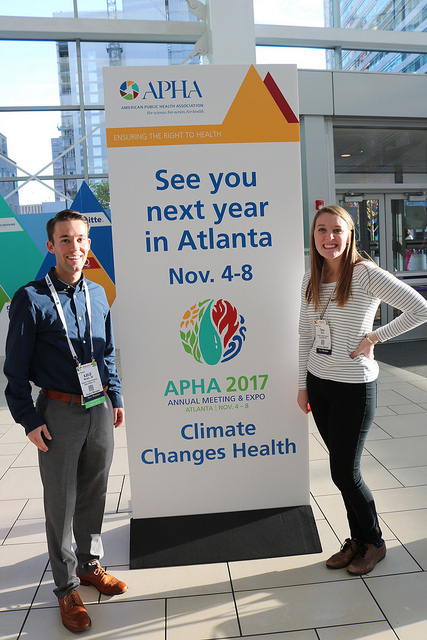man and woman pose with see you next year in Atlanta sign