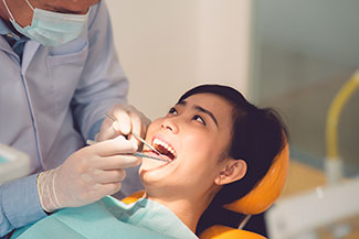 dentist examining woman's mouth
