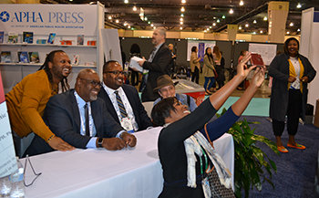 woman taking selfie with racism book authors