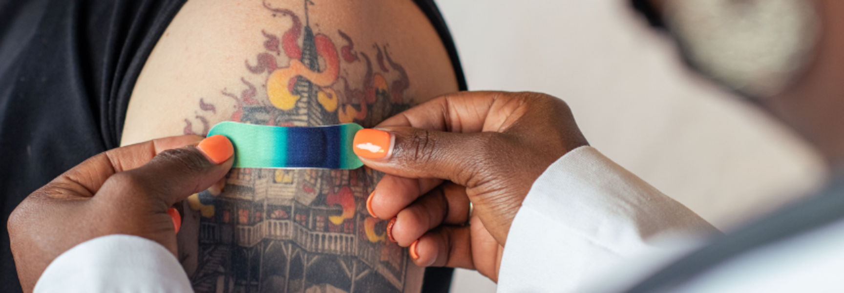 doctor putting on a band aid after a vaccine