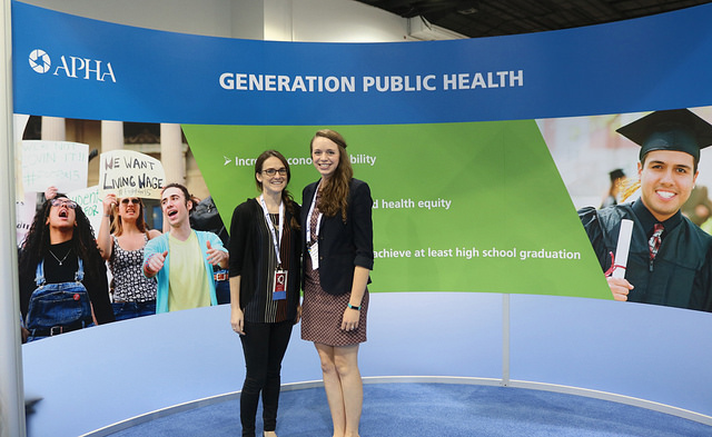 two smiling women at Generation Public Health display