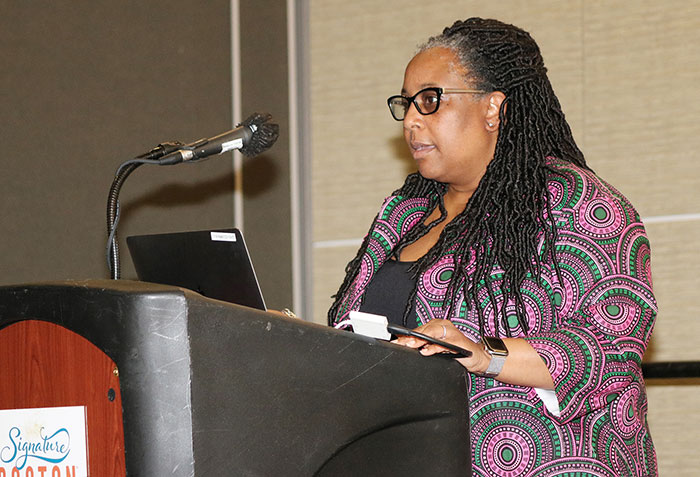 An attendee stands at the podium during a Learning Institute. 