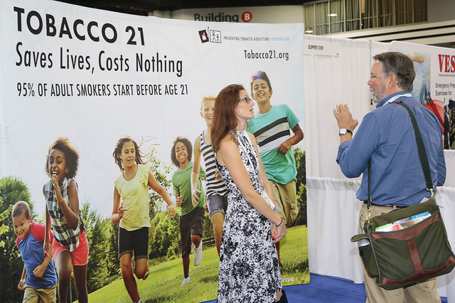 woman and man at Tobacco 21 expo booth
