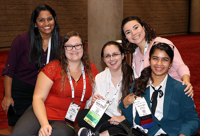 five smiling women showing Annual Meeting name badges