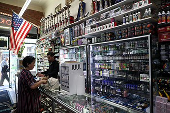 woman at counter with e-cigarettes