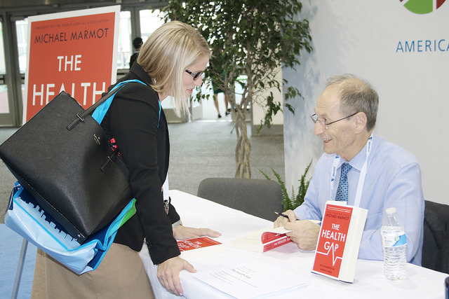 Michael Marmot signs book for fan